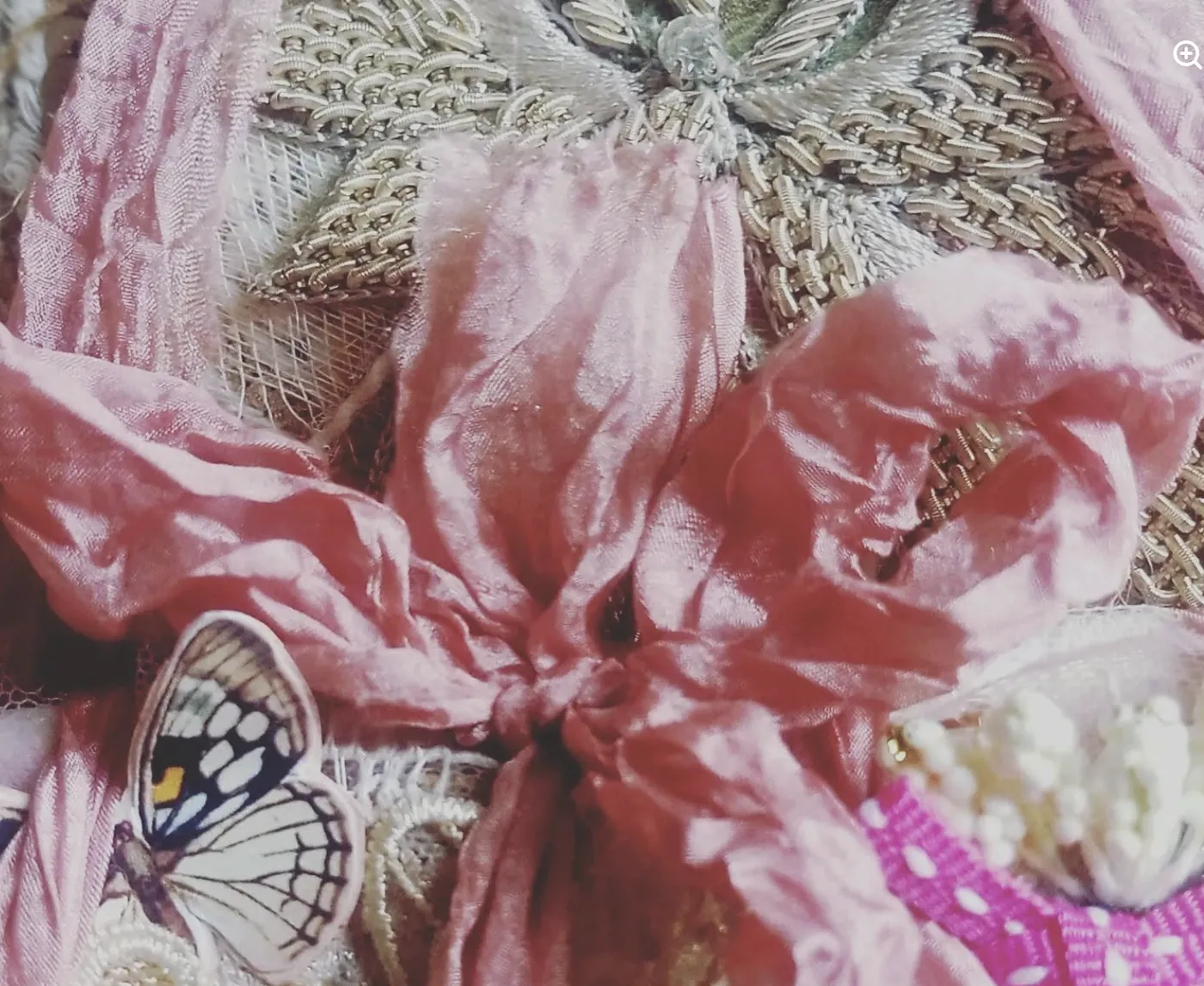 A pink velvet flower and a butterfly on magenta ribbon
