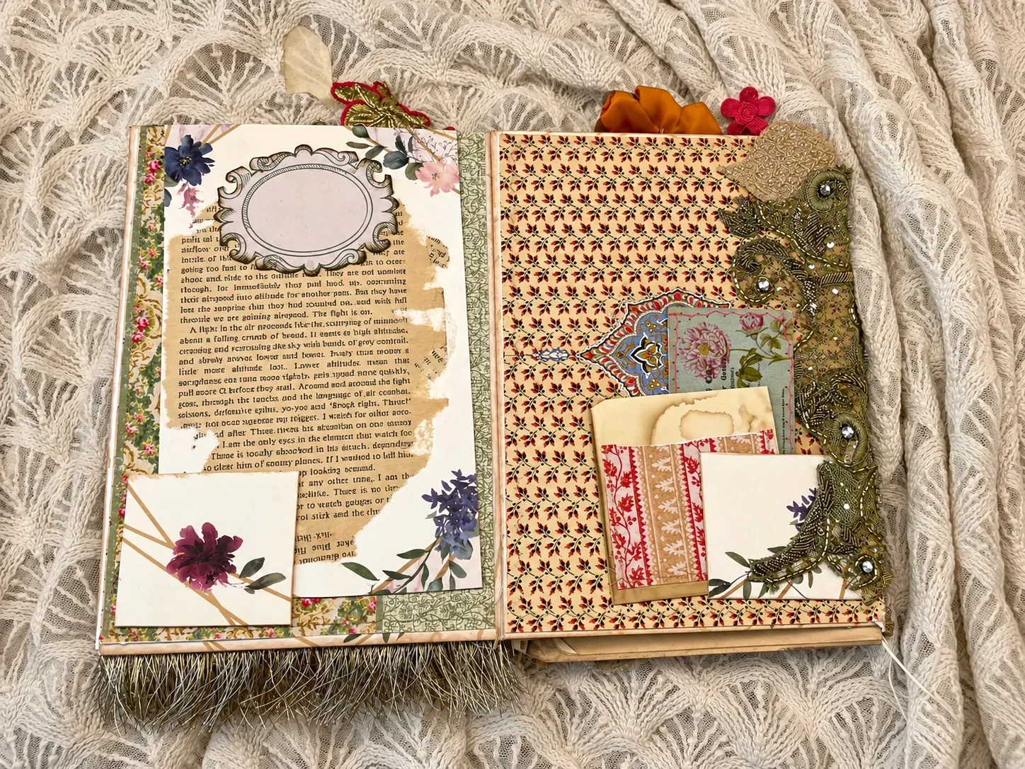 After the Wedding opened to torn book text, botanical collage, an empty ornamental frame and embroidered textile