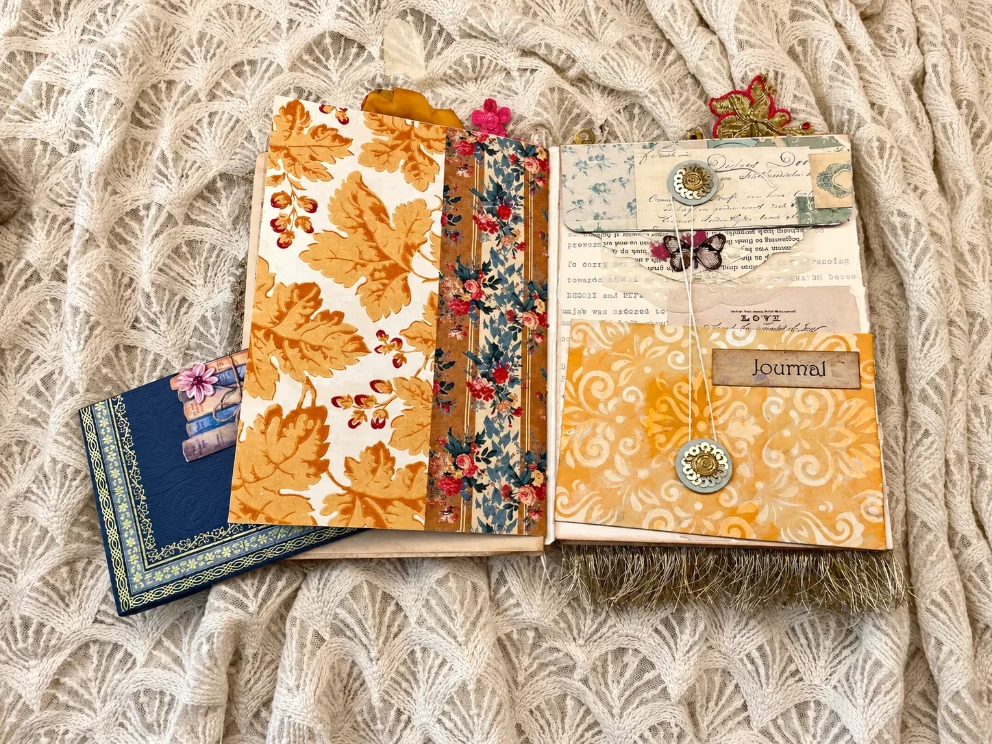 After the Wedding opened to orange botanical paper, a blue book-shaped insert and a yellow pocket with layered writing papers
