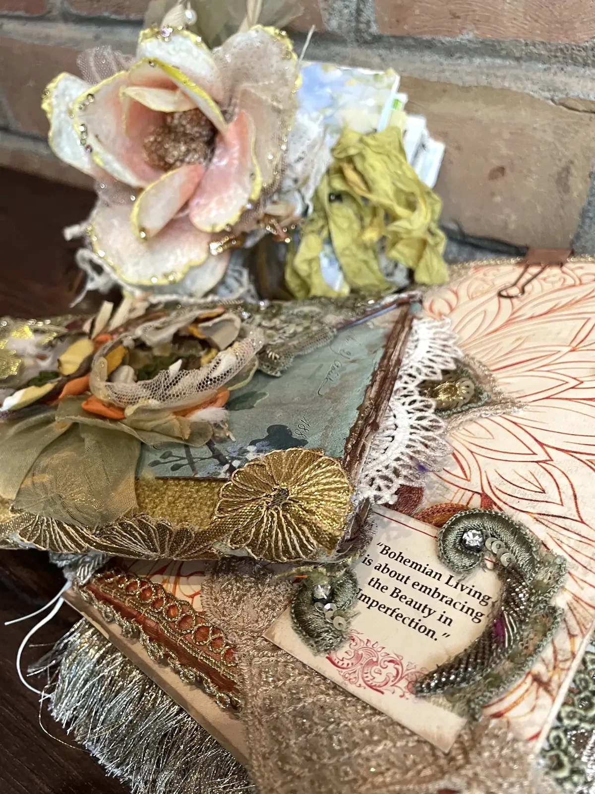The Garden and After the Wedding artist journals arranged together, layered with handmade flowers, sari silk, lace and metallic trims