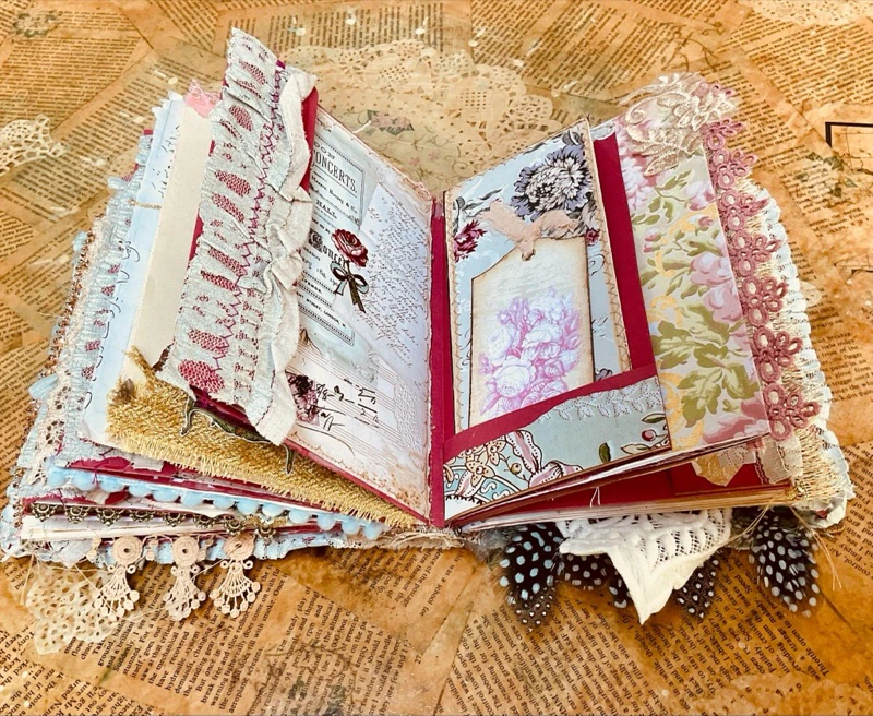 Layered vintage ephemera and collage details inside the Book of Ritz journal