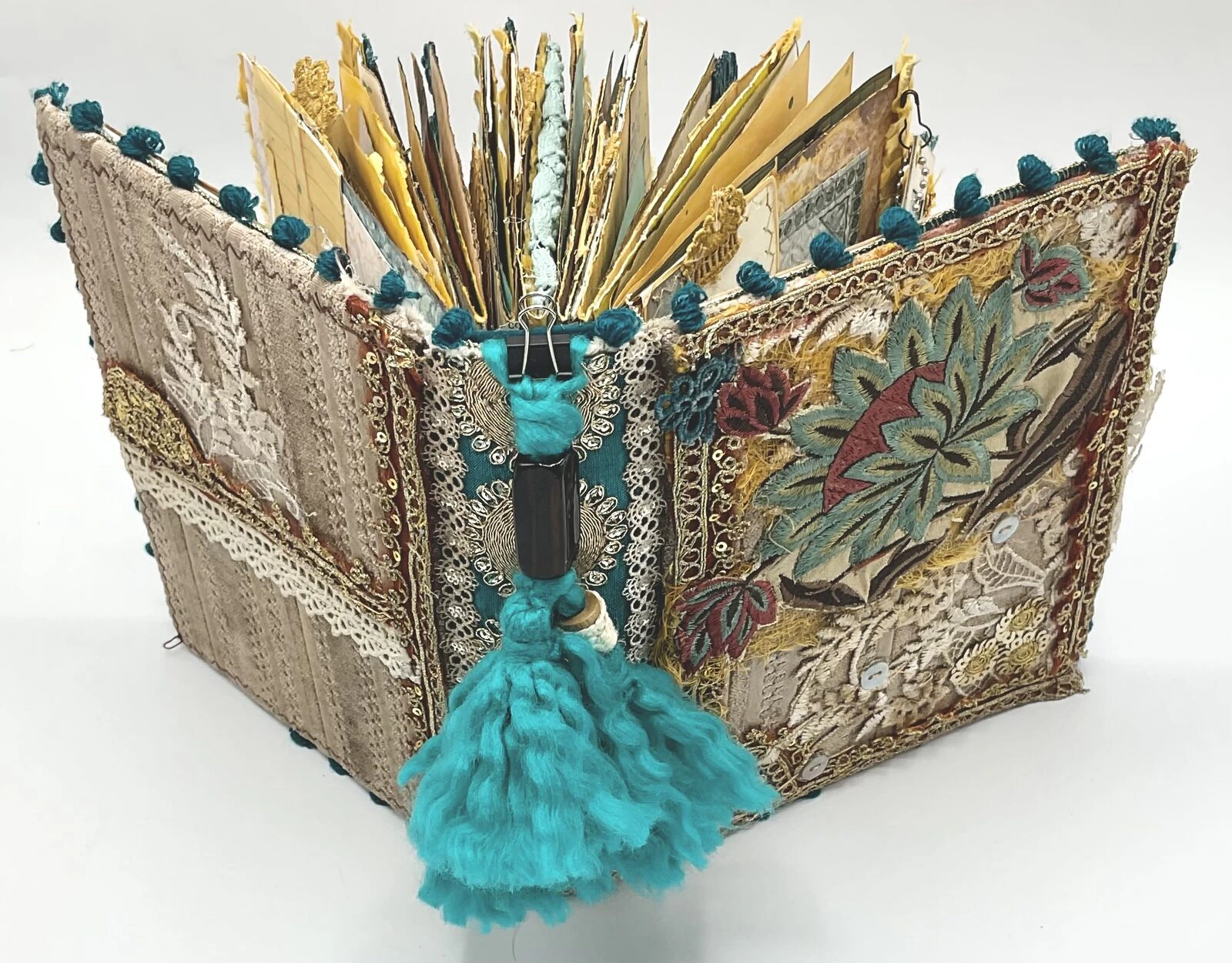 Hand-dyed page with paint splatters in teal fabric junk journal